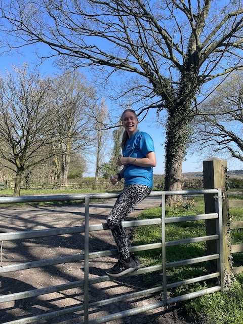 Bev climbing over a fence