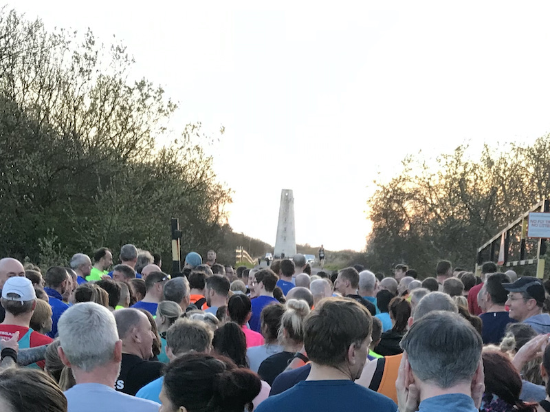 Hundreds of people getting ready to start with Leasowe Lighthouse in the distance