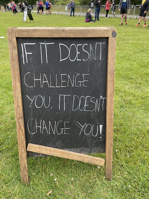 A motivational message on a chalkboard outside: If it doesn't challenge you, it doesn't change you!