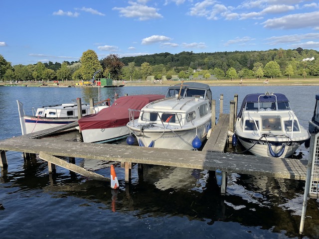Small motor boats lined up on the water's edge