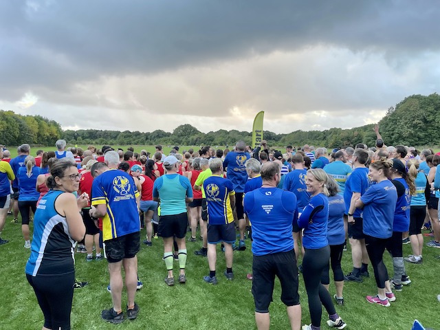 Runners beginning to line up in Arrowe Park, with a threatening sky looming.