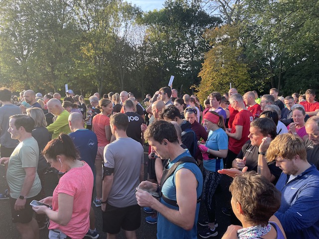 A crowd of people getting ready for parkrun
