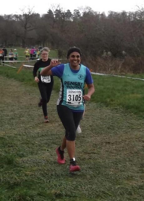 Me with club vest and number running in the cross country.