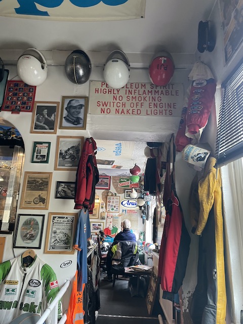 Small rooms in the bikers cafe filled with helmets, shirts and photographs