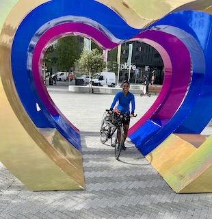 Me with bike within the heart statue put up for the Eurovision song contest in Liverpool recently