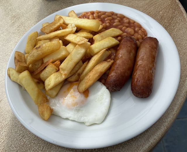 Chips, beans, two sausages, and an egg for my lunch.