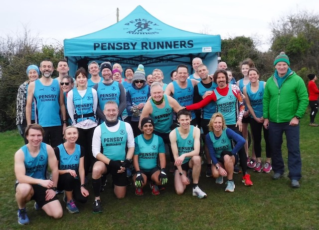 Big group of Pensby runners in front of our gazebo posing for a group photo