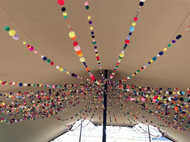 strings of coloured balls stringing out from the ceiling of the tent