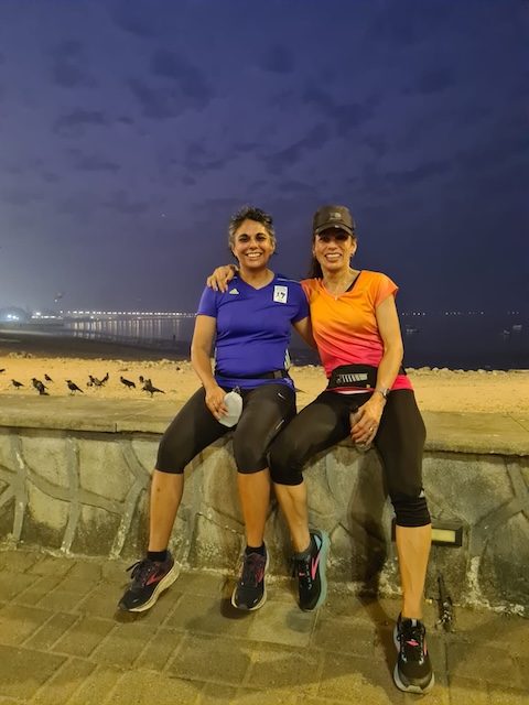 Me and Hersha on the wall in the dark (street lights on us) with Chowpatty Beach in the background and the Arabian Sea behind that