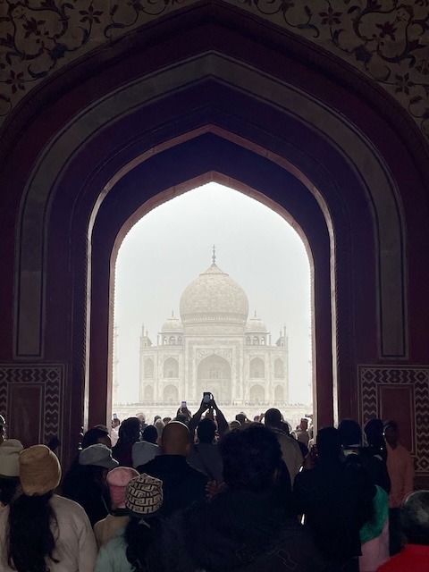 The Taj Mahal in the background with through the arch of one of the entrance buildings.
