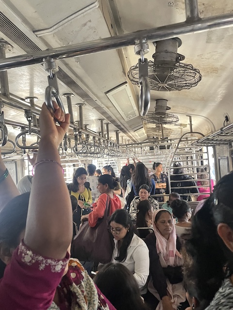 A full carriage for women only. Fans on the ceiling and metal benches.