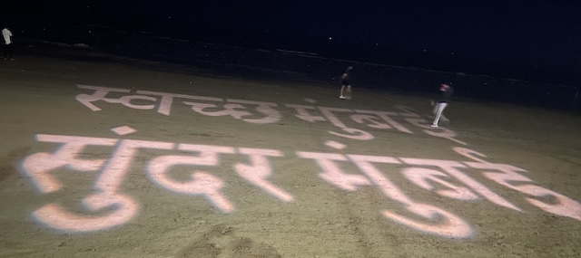 Clean Mumbai, Green Mumbai slogan in Hindi projected onto the beach