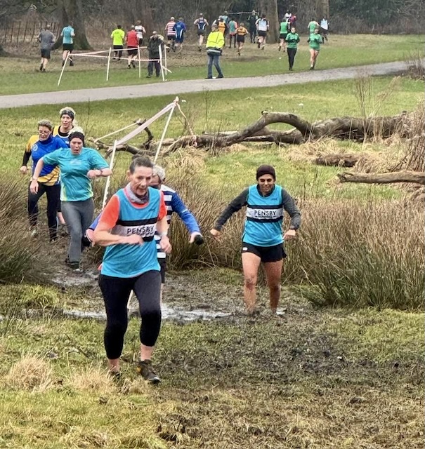 A fellow Pensby runner, Cath in the foreground and me and Stan emerging from the bog behind her.