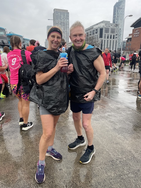 Two runners wearing bin bags to keep them from getting cold and wet