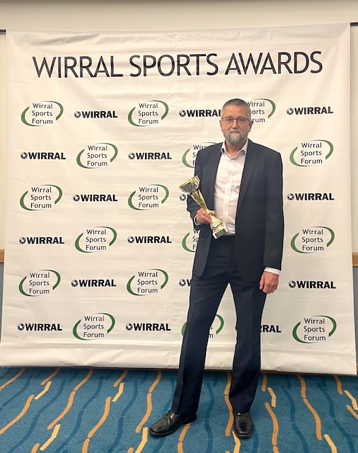 Nigel with our winner's award with the Wirral Sports Award as a back drop.