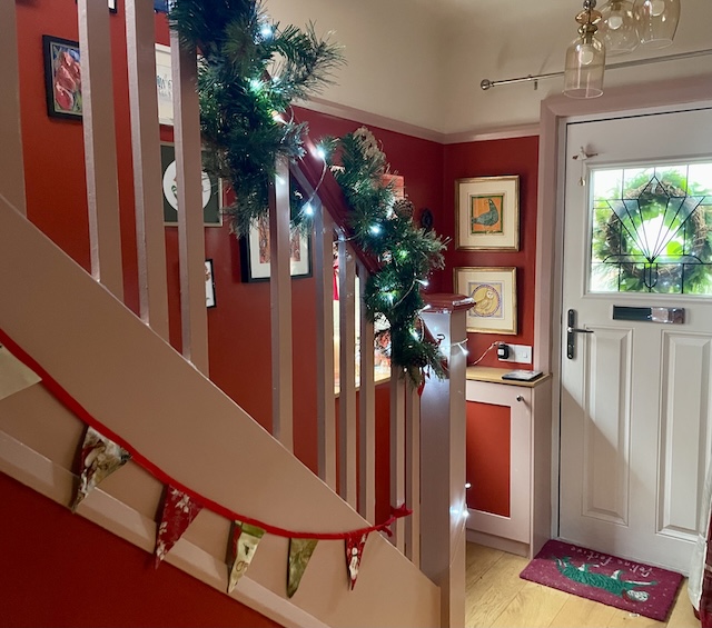  Hallway with festive false evergreens and Christmas lights