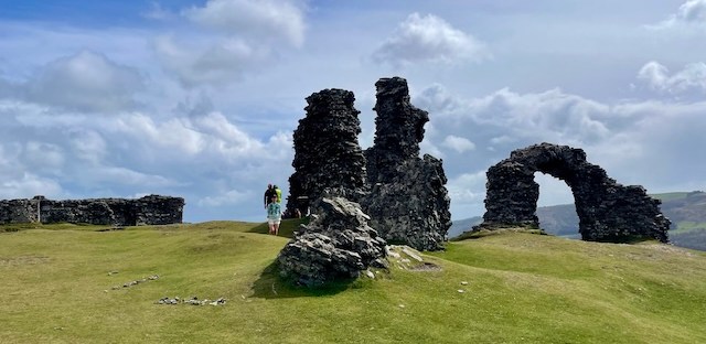 The ruins of Castell Dinas Brân against a blue sky with some white clouds