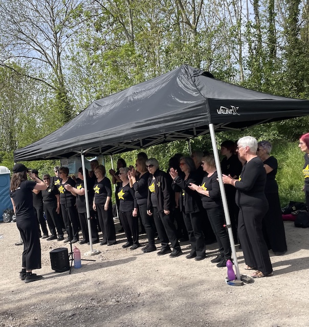 A choir along the Greenway singing us in