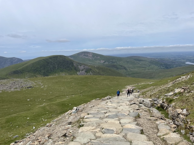 A view of the path with rolling hills in the background.