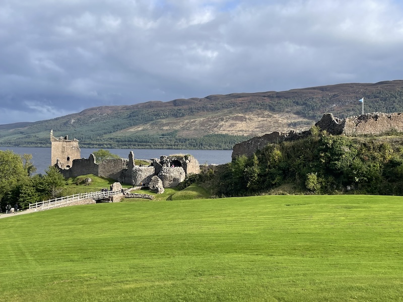 Hills in the background and some of Loch Ness water, and then the ruins of the castle and then well lawned grass in the foreground.