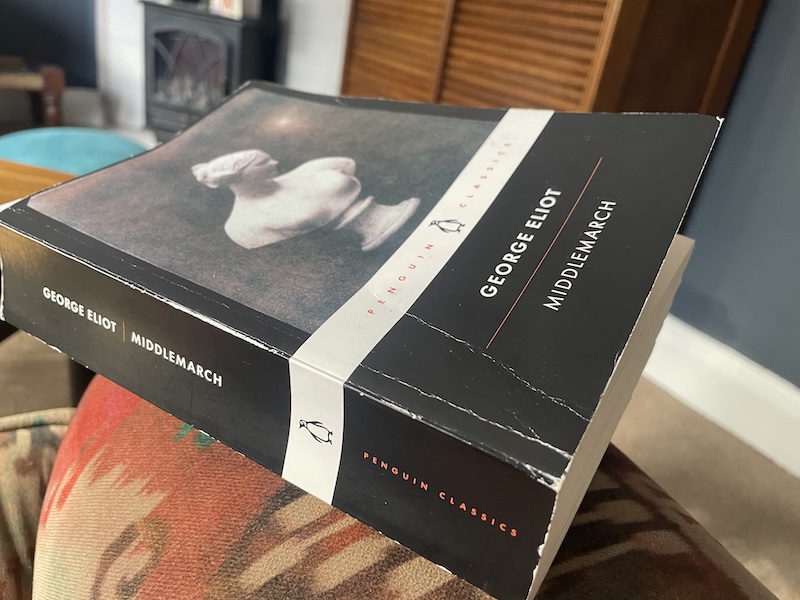 Book of Penguin Classics edition of Middlemarch on the sofa arm in the living room.